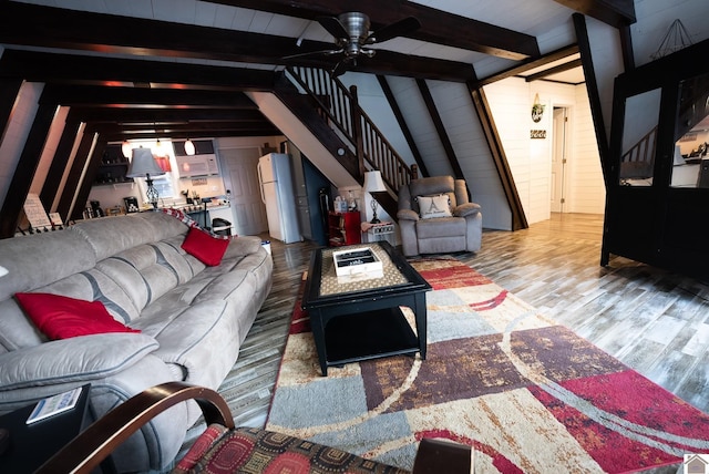 living room with hardwood / wood-style flooring, vaulted ceiling with beams, and ceiling fan