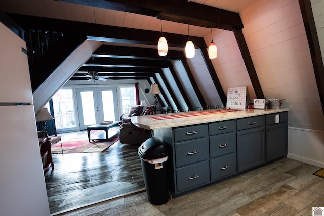 kitchen featuring pendant lighting, lofted ceiling with beams, dark hardwood / wood-style flooring, ceiling fan, and french doors