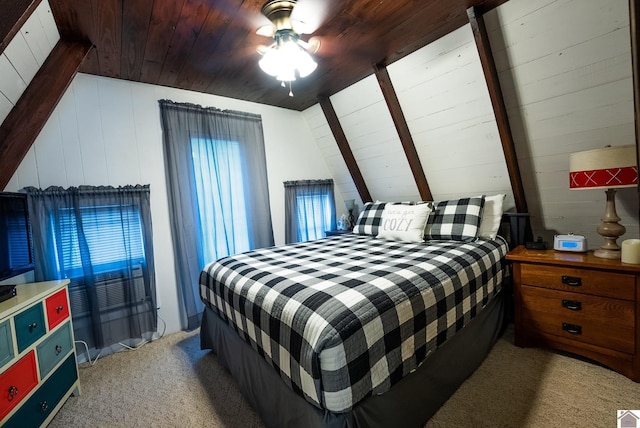 carpeted bedroom featuring vaulted ceiling, wood ceiling, and wood walls