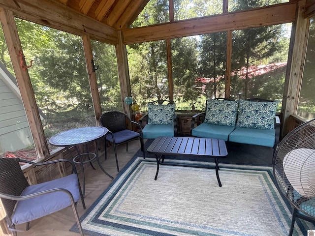 sunroom / solarium featuring lofted ceiling