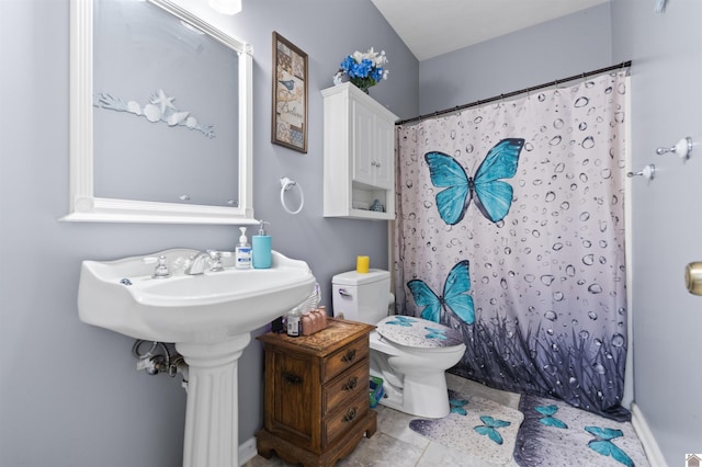 bathroom featuring toilet and a shower with shower curtain