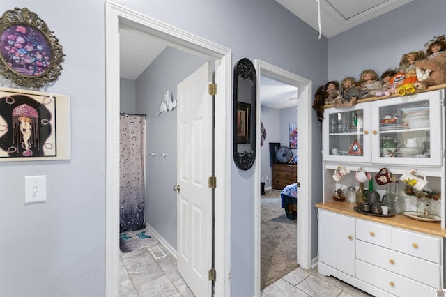 hallway with light colored carpet