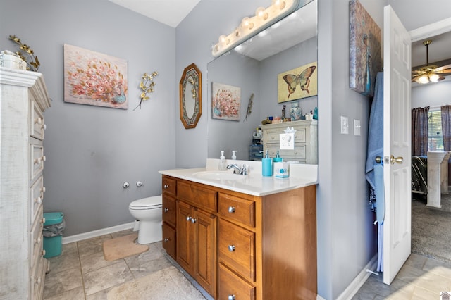 bathroom with vanity, ceiling fan, and toilet