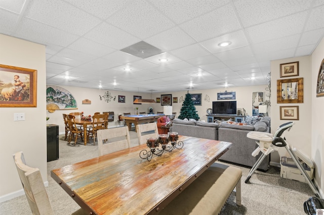 carpeted dining area featuring a paneled ceiling and pool table