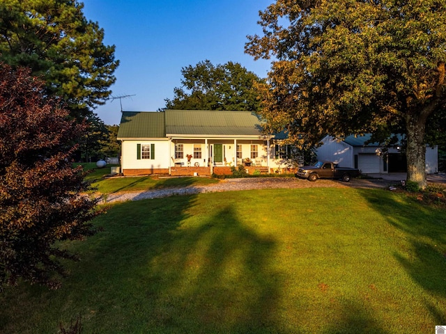 view of front of home with a porch, a garage, and a front yard