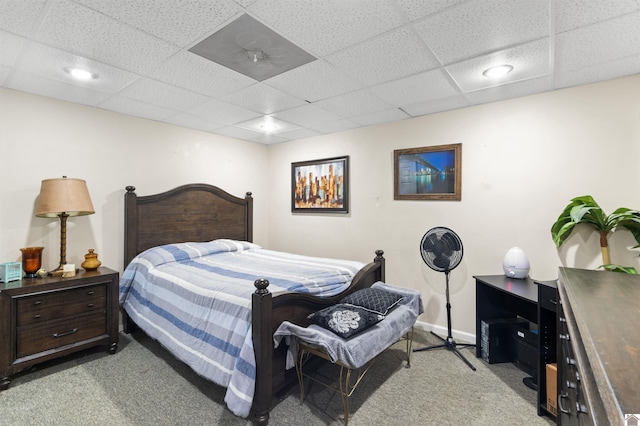 bedroom featuring light colored carpet and a paneled ceiling