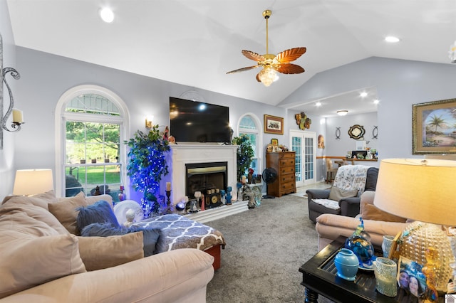 carpeted living room featuring ceiling fan and lofted ceiling