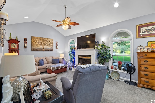 carpeted living room featuring ceiling fan and vaulted ceiling