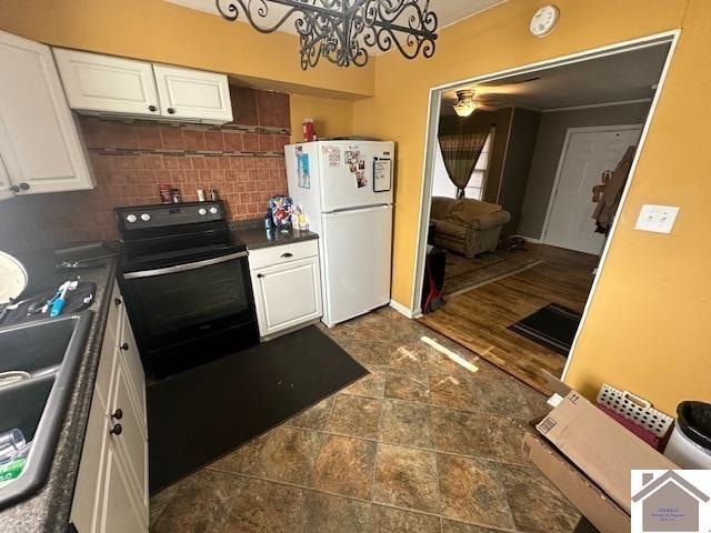 kitchen featuring white refrigerator, electric range oven, white cabinetry, backsplash, and dark wood-type flooring