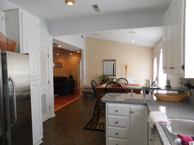 kitchen featuring dark wood-type flooring, white cabinetry, and stainless steel fridge