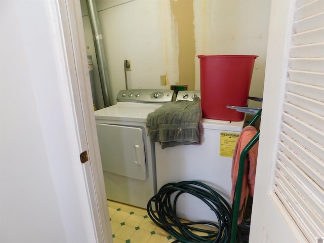 laundry room with washing machine and clothes dryer and tile patterned flooring