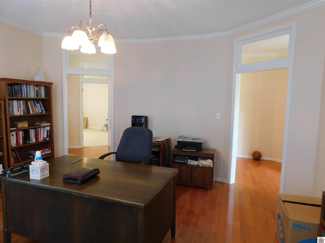 office featuring hardwood / wood-style flooring, ornamental molding, and an inviting chandelier