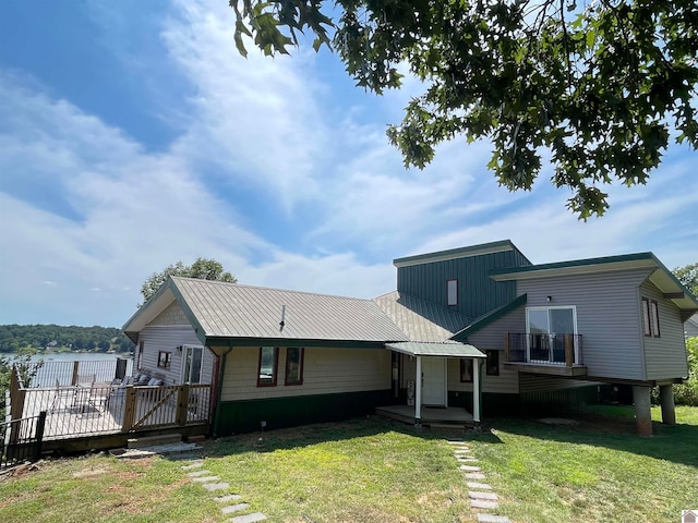 view of front of house with a front lawn and a wooden deck