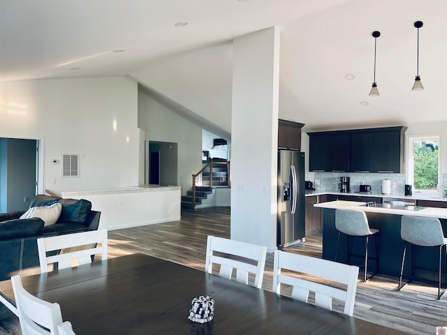 interior space with high vaulted ceiling and dark hardwood / wood-style flooring