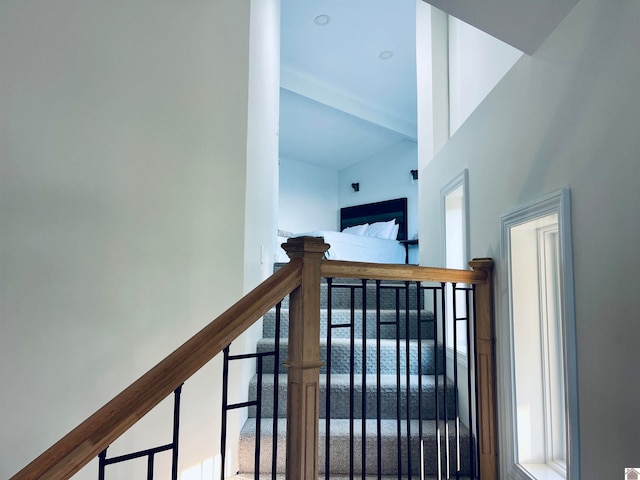 stairs featuring a high ceiling