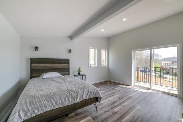 bedroom with access to exterior, light hardwood / wood-style flooring, and vaulted ceiling with beams