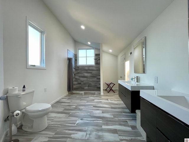 bathroom with lofted ceiling, vanity, and toilet