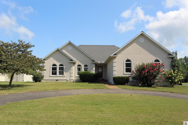 single story home featuring a front lawn