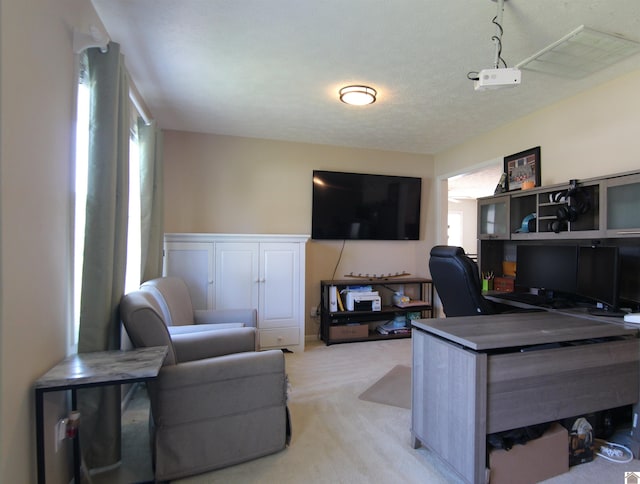 carpeted office with a textured ceiling