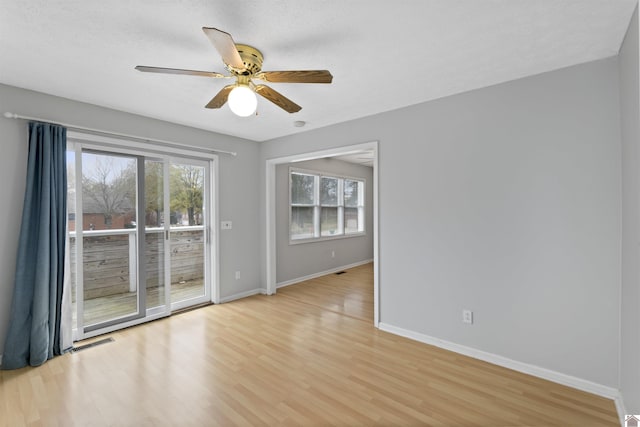 empty room featuring ceiling fan and light hardwood / wood-style floors