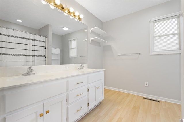 bathroom featuring vanity, wood-type flooring, and a shower with shower curtain