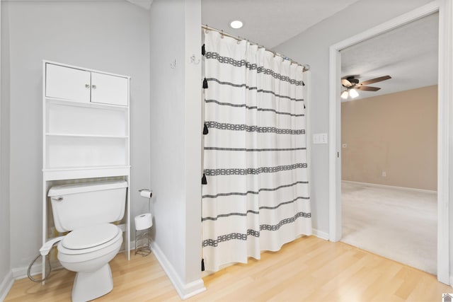 bathroom featuring hardwood / wood-style floors, a textured ceiling, ceiling fan, and toilet