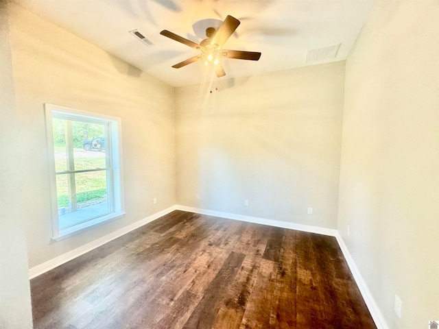 spare room with ceiling fan and dark wood-type flooring