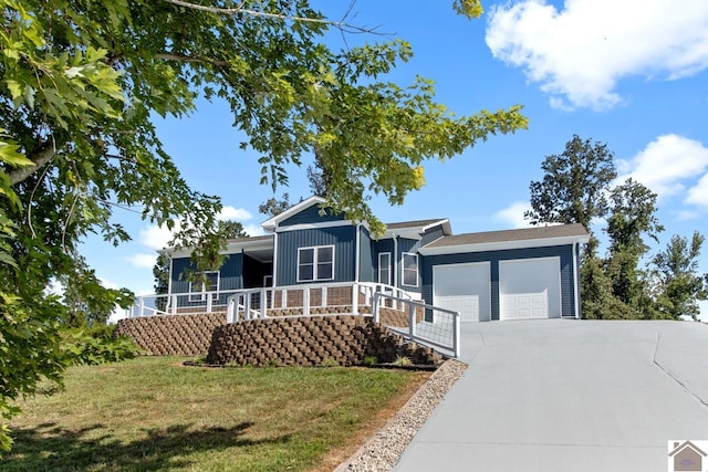 view of front of house with a front yard and a garage