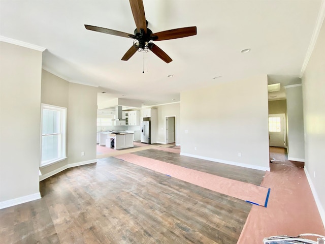 unfurnished living room with light wood-type flooring, crown molding, and ceiling fan