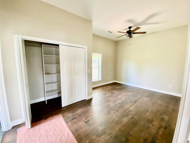 unfurnished bedroom with ceiling fan and dark hardwood / wood-style floors