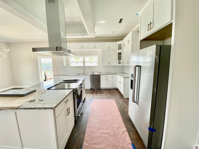 kitchen with appliances with stainless steel finishes, white cabinetry, light stone counters, island exhaust hood, and dark wood-type flooring