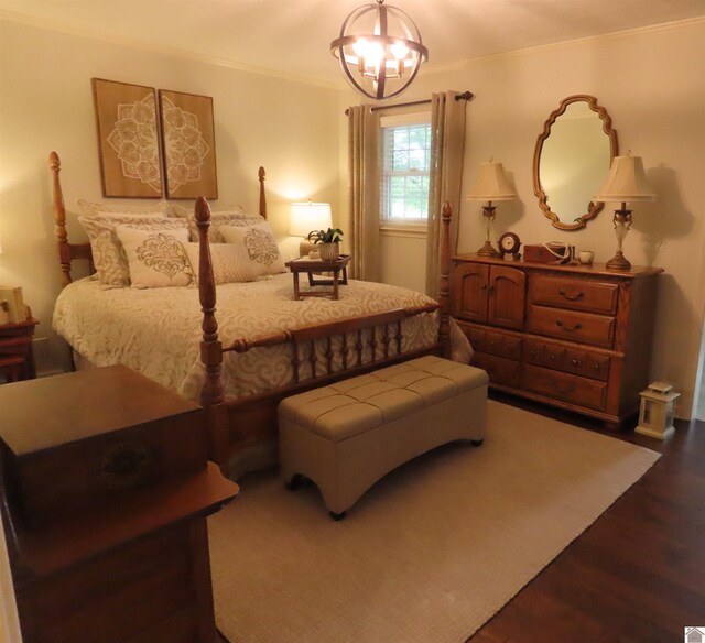 bedroom with hardwood / wood-style flooring and a chandelier