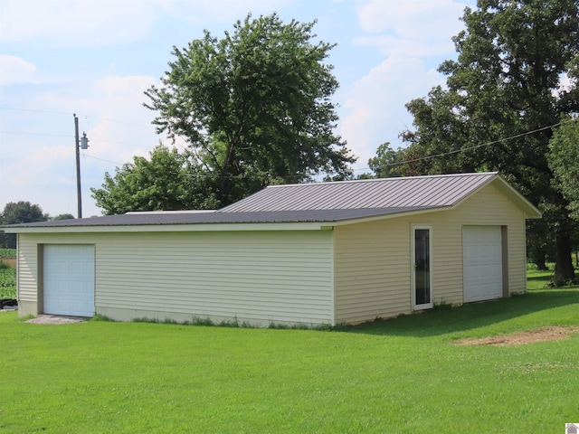 garage featuring a lawn