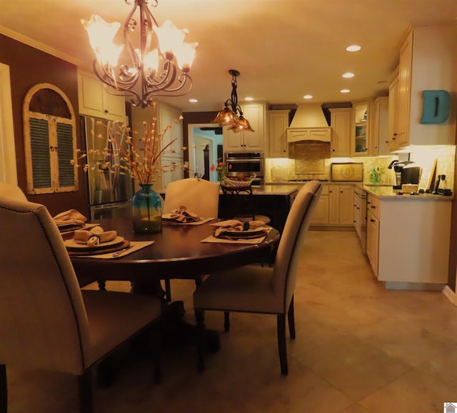 dining space featuring light tile patterned floors, a chandelier, and crown molding