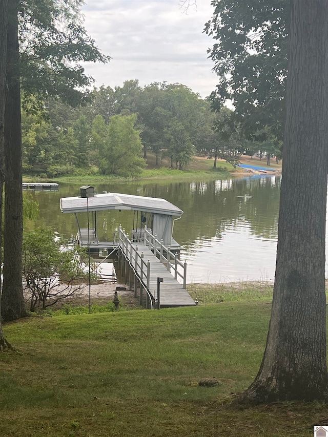 view of dock featuring a water view and a lawn