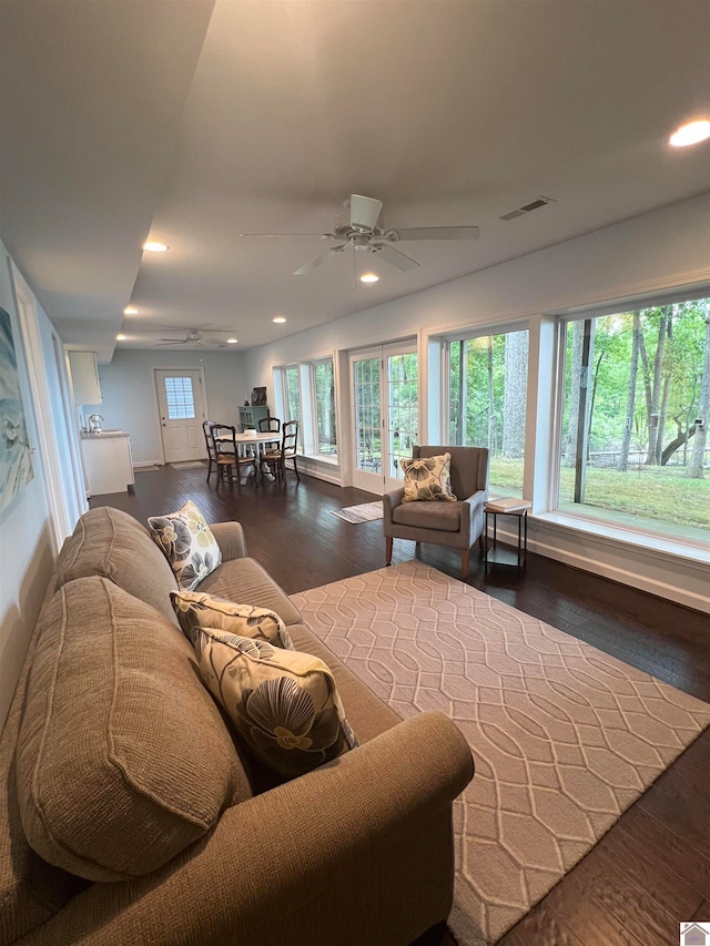 living room with ceiling fan and dark hardwood / wood-style floors