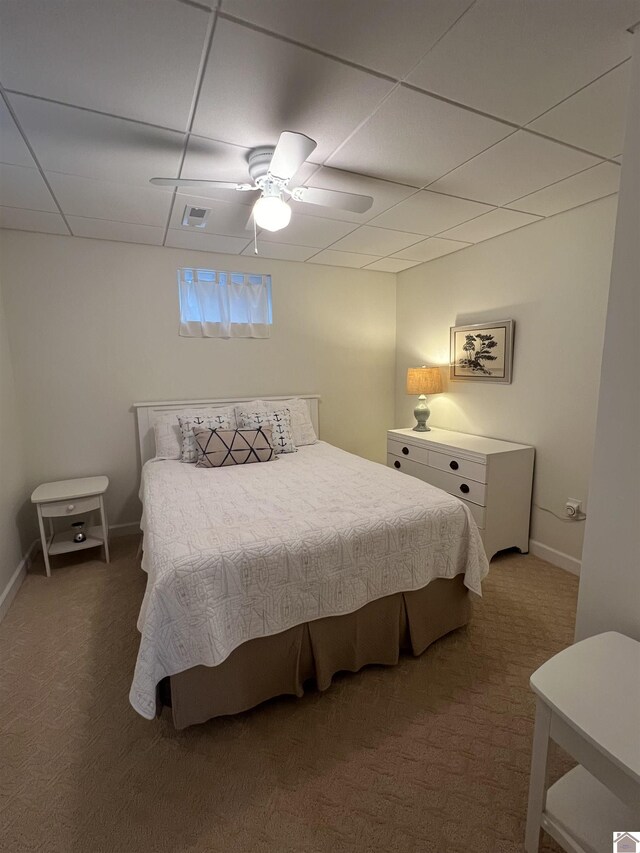 carpeted bedroom featuring a paneled ceiling and ceiling fan