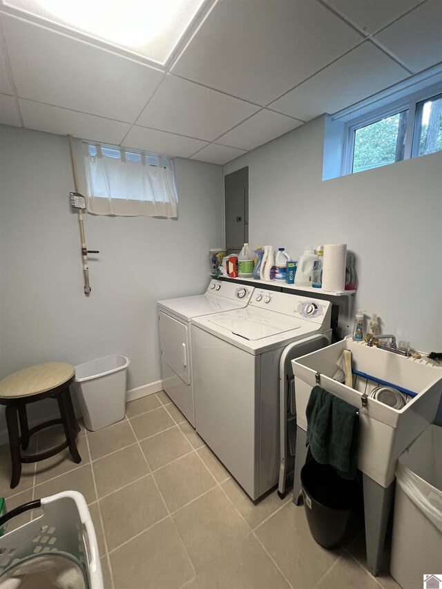 washroom with electric panel, independent washer and dryer, and tile patterned flooring