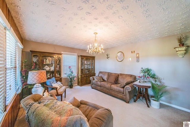 living room featuring a notable chandelier, a textured ceiling, and light carpet