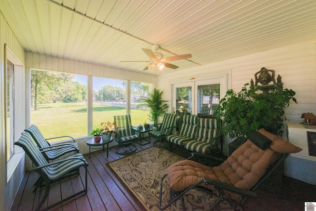 sunroom / solarium featuring wood ceiling and ceiling fan