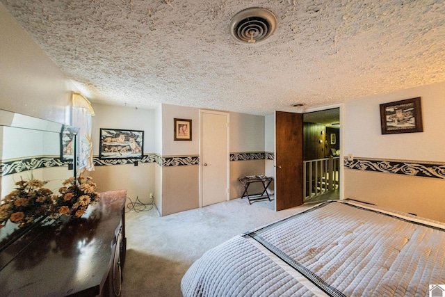 carpeted bedroom featuring a textured ceiling