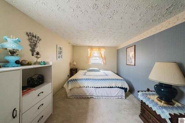 bedroom with light carpet and a textured ceiling