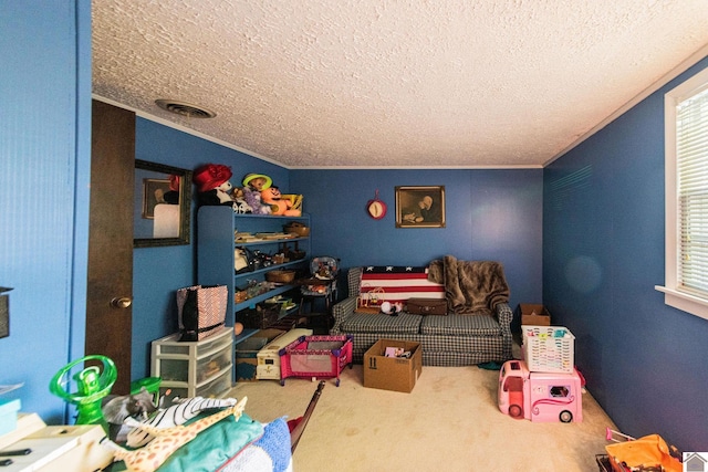 game room featuring crown molding, visible vents, carpet floors, and a textured ceiling