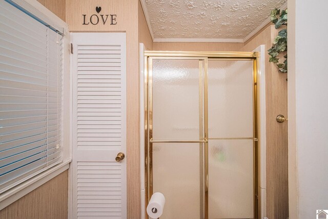 bathroom with ornamental molding and a textured ceiling