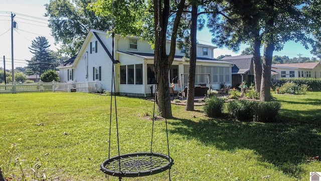 rear view of property with a lawn