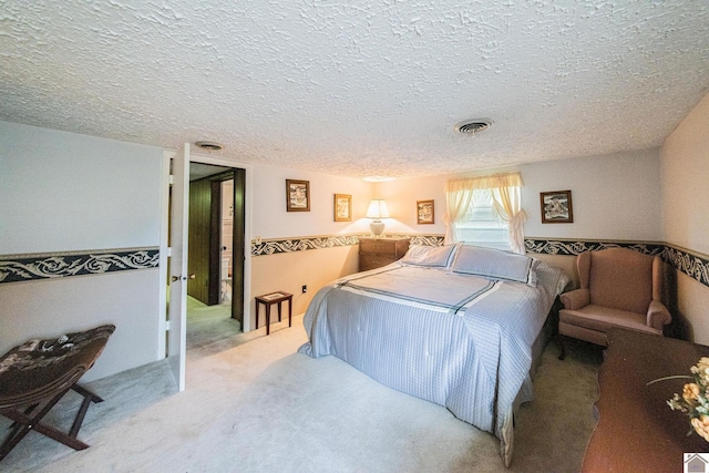 bedroom featuring carpet floors and a textured ceiling