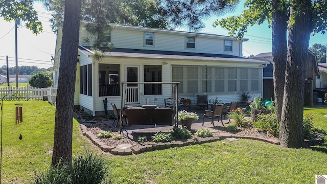 traditional-style house featuring a front lawn, fence, a patio, and a sunroom