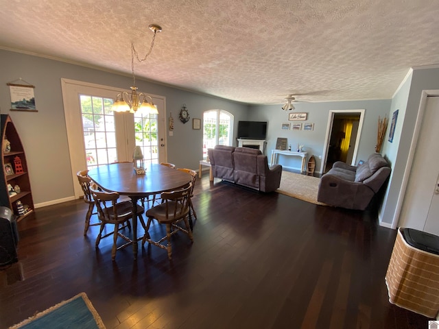 dining area with crown molding, dark hardwood / wood-style flooring, a chandelier, and a textured ceiling