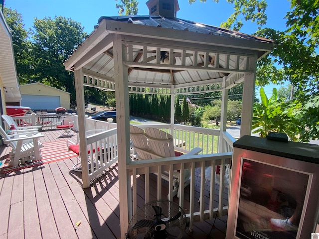 deck with an outdoor structure and a garage