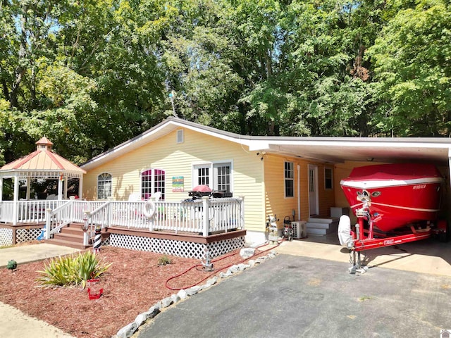 single story home with a deck and a gazebo